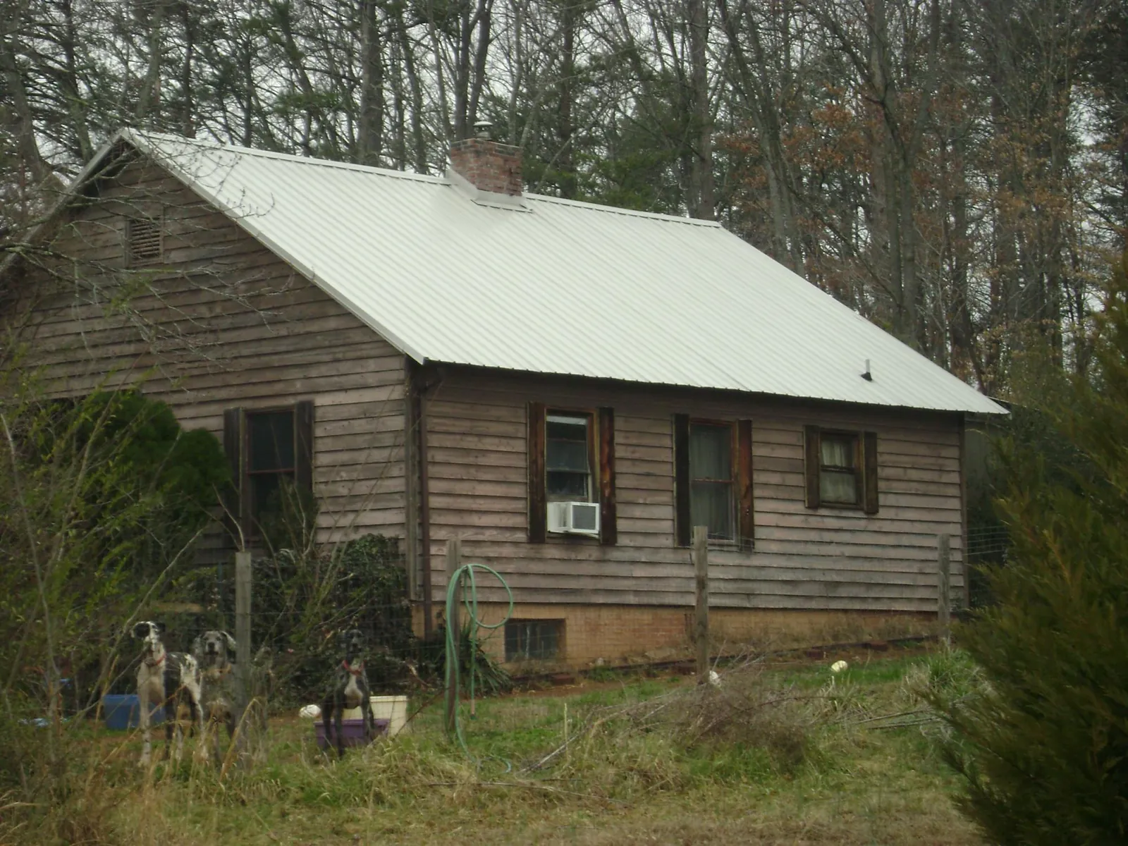 White metal roof on an old wood sided farmhouse, from a Metal Roof Installation job in West Bridgewater